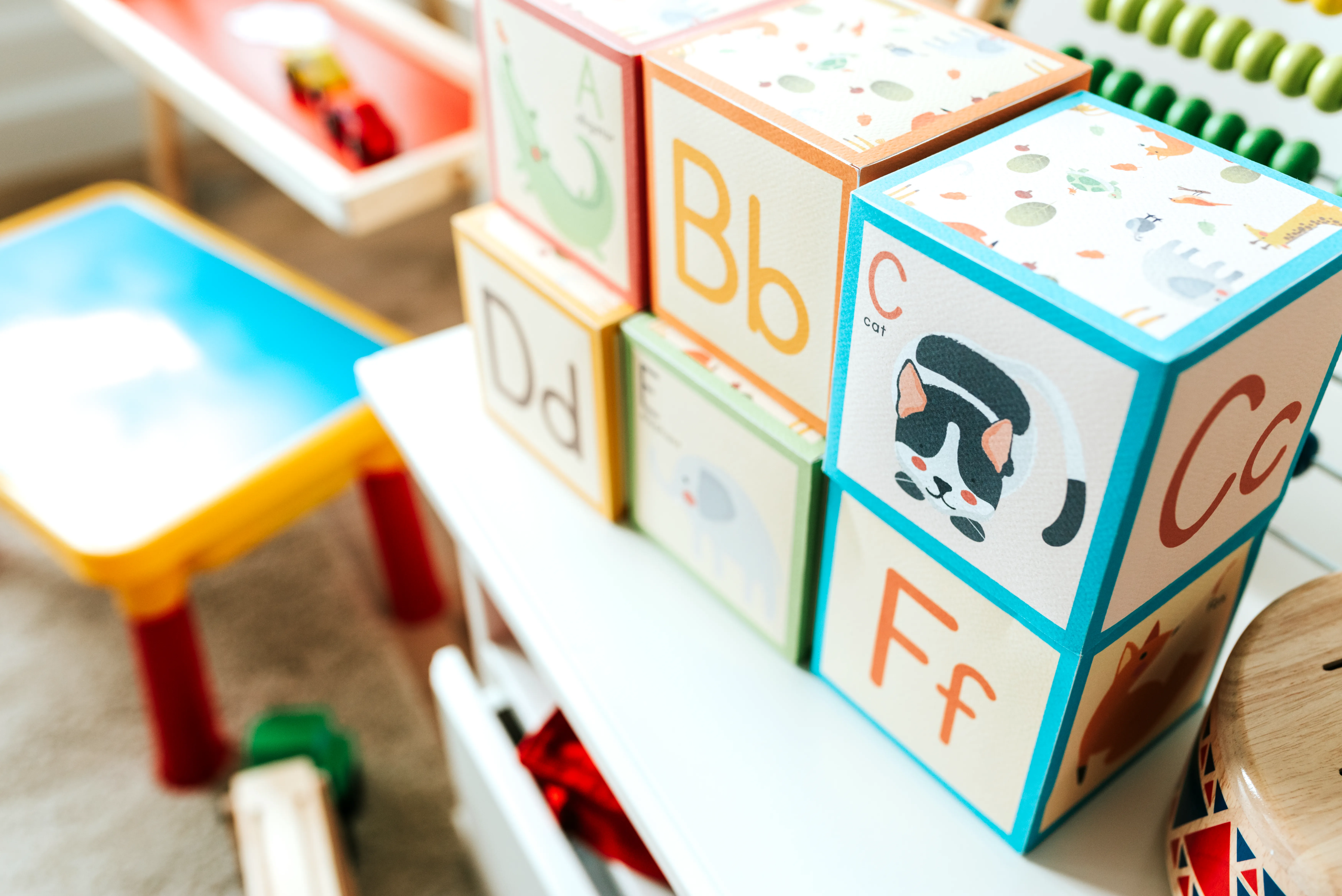 Colourful illustrated alphabet blocks in a nursery play area
